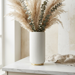 Arca Ribbed Ceramic Vase with pampas grass against plaster wall