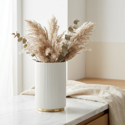 Arca Ribbed Ceramic Vase with eucalyptus and linen on marble surface
