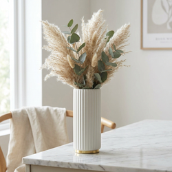 Arca Ribbed Ceramic Vase styled on marble dining table with natural stems